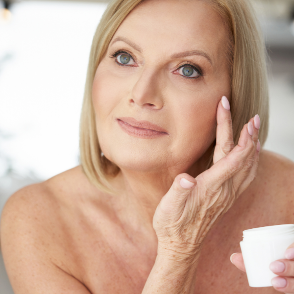 Woman adding creams to face